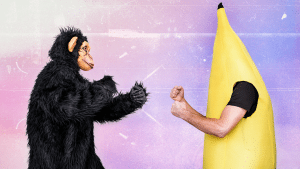 picture of a monkey and guy in banana suit fighting