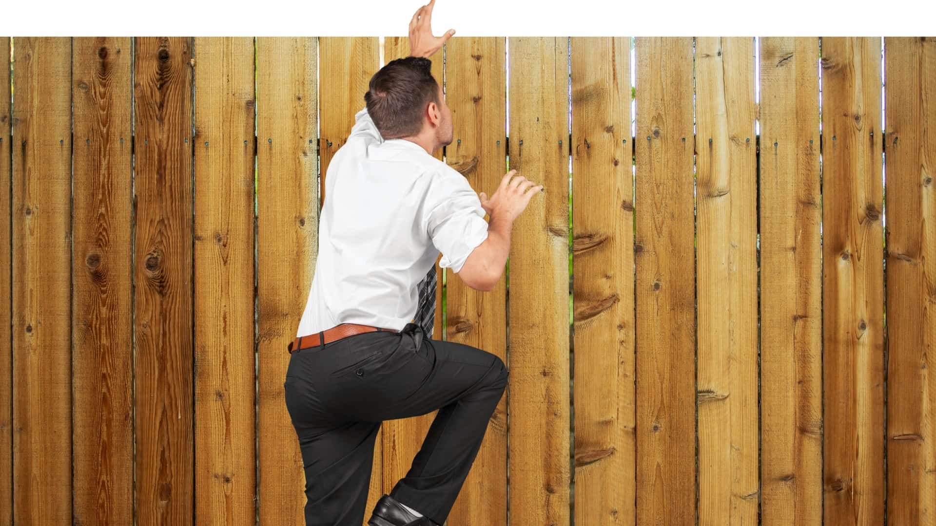 picture of a man climbing a fence