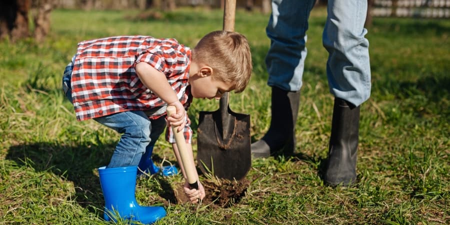 picture of a man and kid digging a hole
