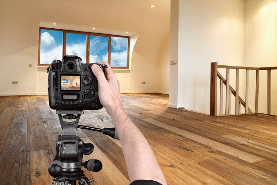 picture of a professional real estate photographer taking a picture of a house