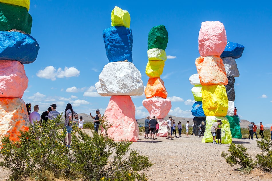 picture of LAS VEGAS, NEVADA, USA - 12 MAY, 2019: Seven Magic Mountains art installation near Las Vegas city. Pillars made of neon colored boulders stand against barren desert background and blue sky