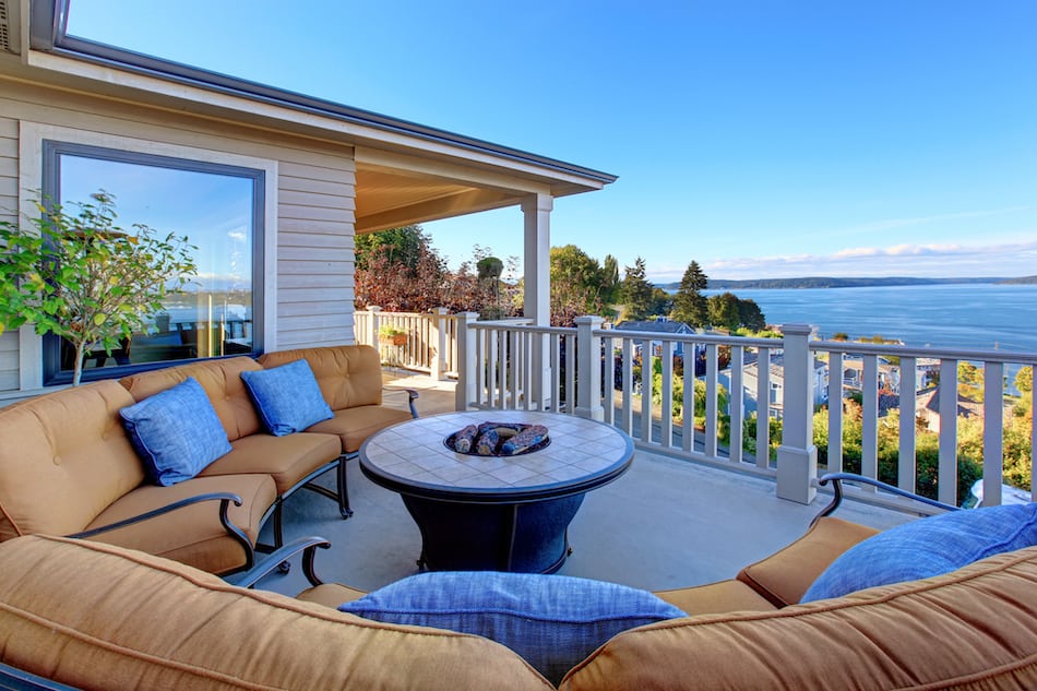 picture of Cozy patio area with comfort settees and fire pit. Deck with Puget Sound view. Tacoma, WA