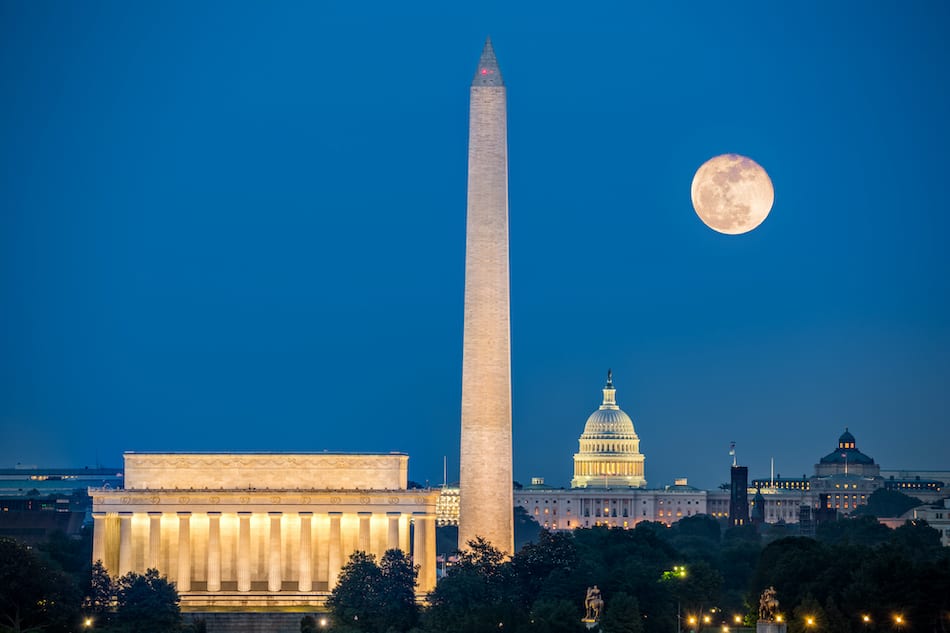 Supermoon above three iconic monuments: Lincoln Memorial, Washington Monument and Capitol Building in Washington DC as viewed from Arlington, Virginia