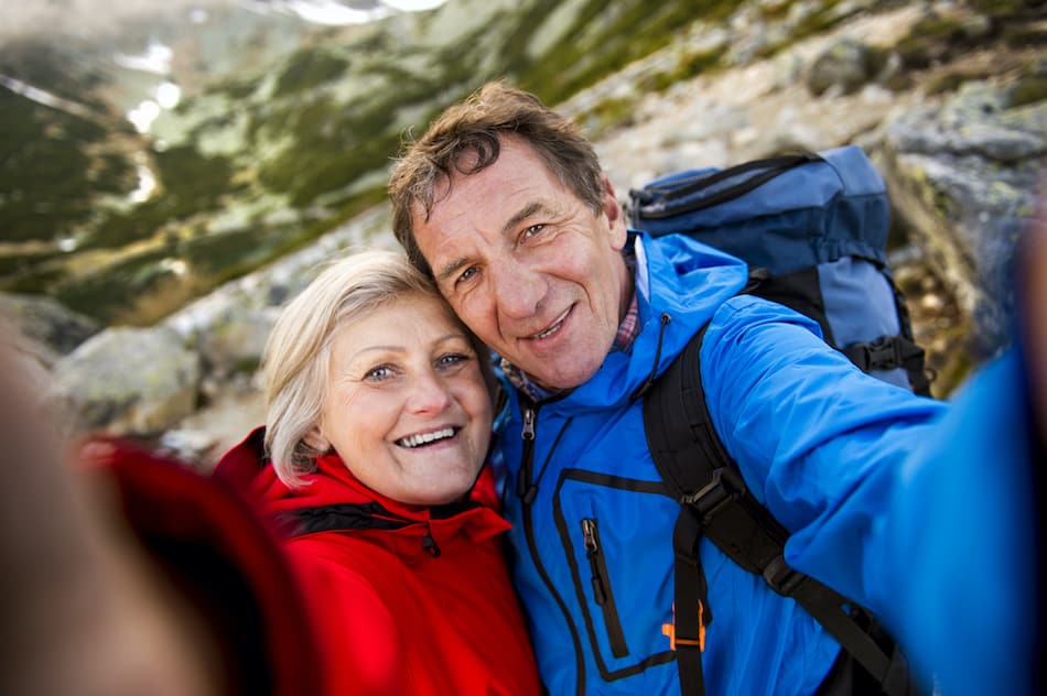 picture of a retired couple hiking on a mountain